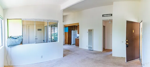 a view of a big room with closet and windows