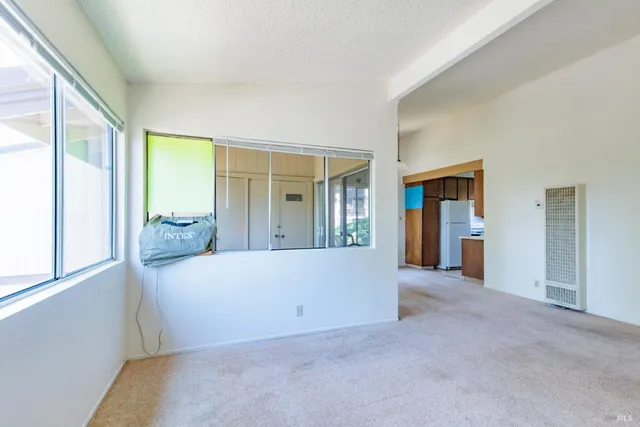 a view of a big room with windows and furniture