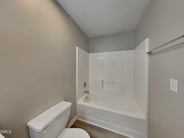 a bathroom with a bathtub and a toilet
