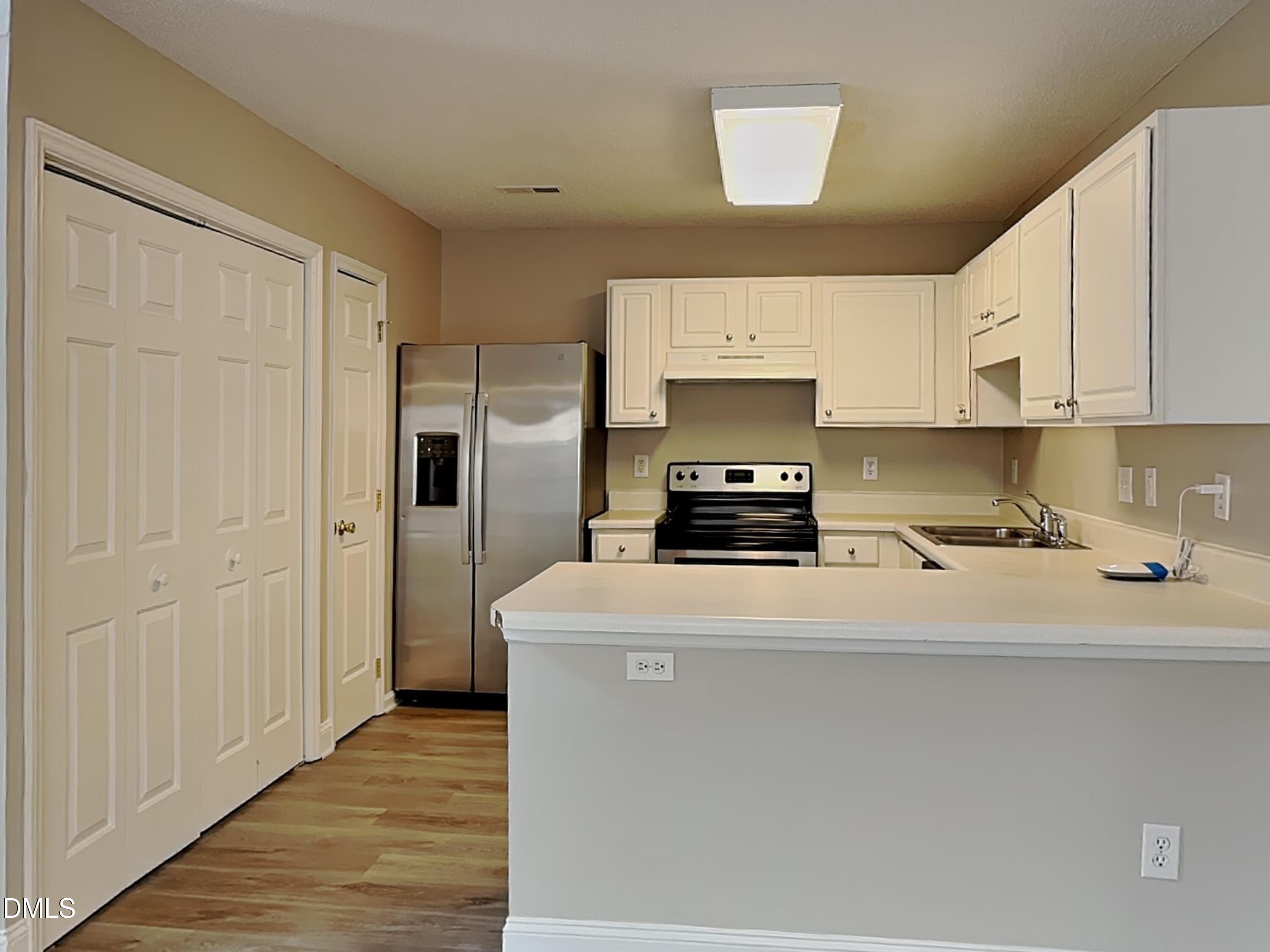 1716 Beacon Valley Drive Raleigh, NC 27604 - Photo 5 of 15 a kitchen with a refrigerator a stove top oven a sink and dishwasher