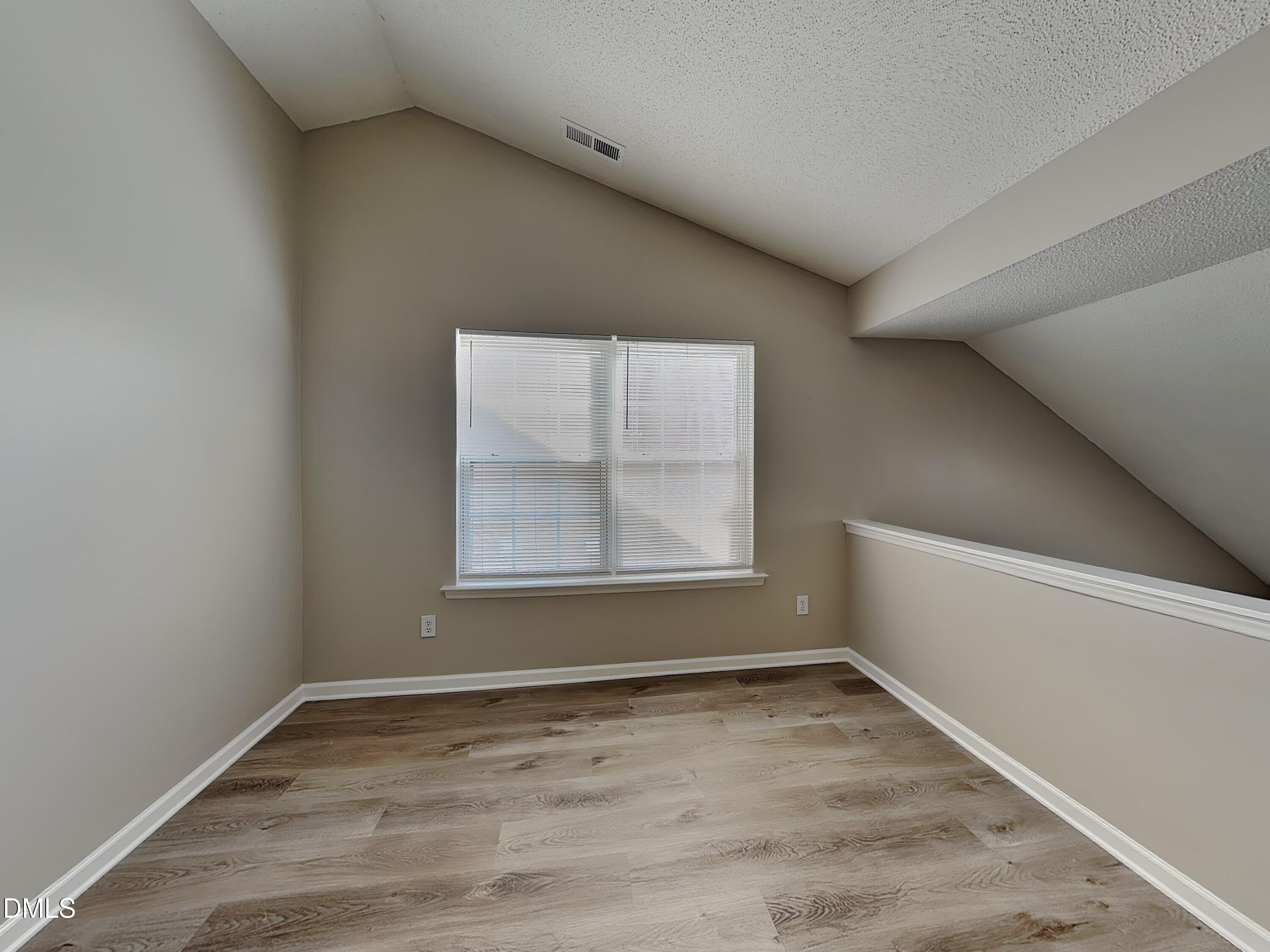 1716 Beacon Valley Drive Raleigh, NC 27604 - Photo 7 of 15 an empty room with a empty space and windows