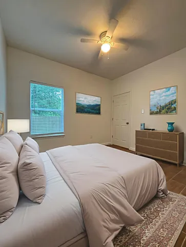 a bedroom with a bed and a painting on the wall