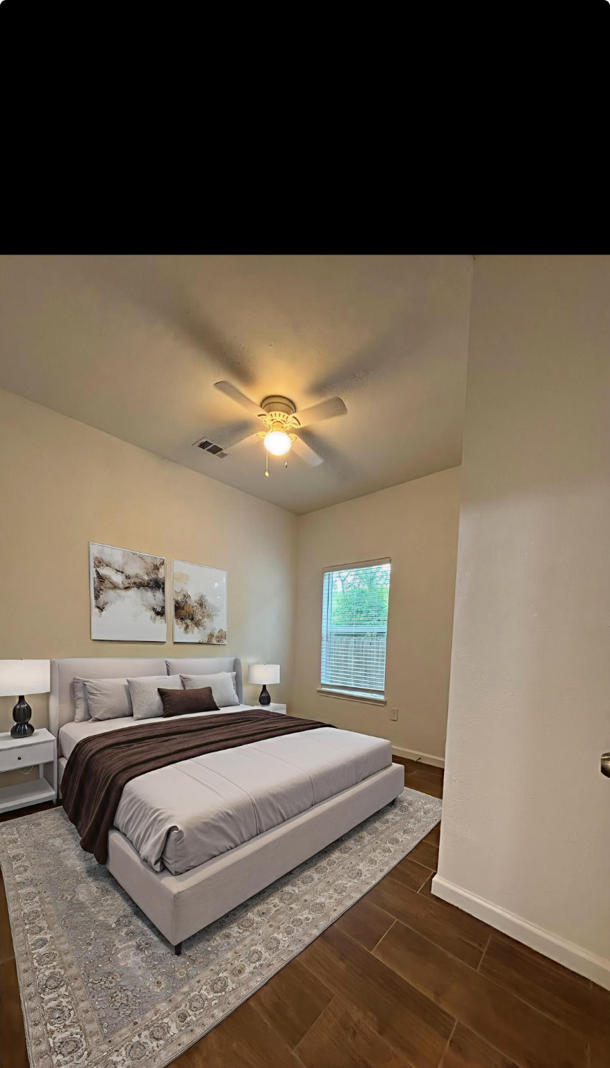 9834 Pelsey Street, Unit B Houston, TX 77029 - Photo 18 of 22 a spacious bedroom with a bed and a ceiling fan