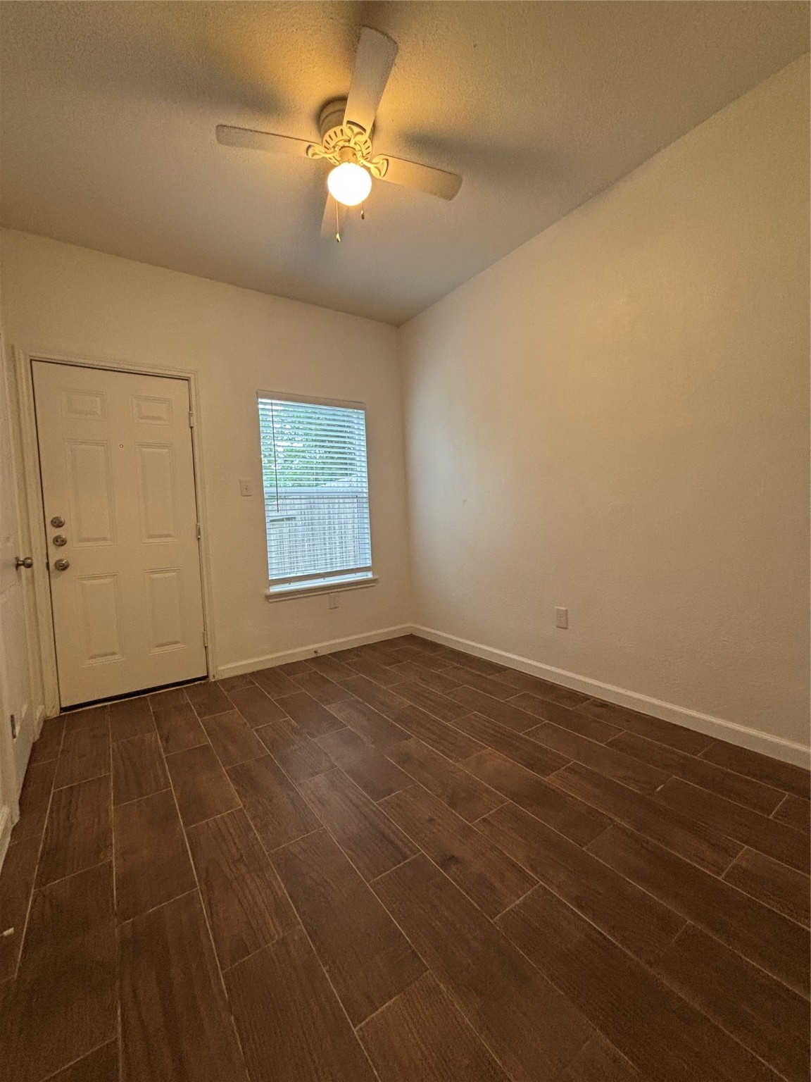 9834 Pelsey Street, Unit B Houston, TX 77029 - Photo 19 of 22 an empty room with windows and fan