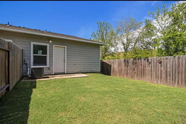 a view of backyard of house and wooden deck