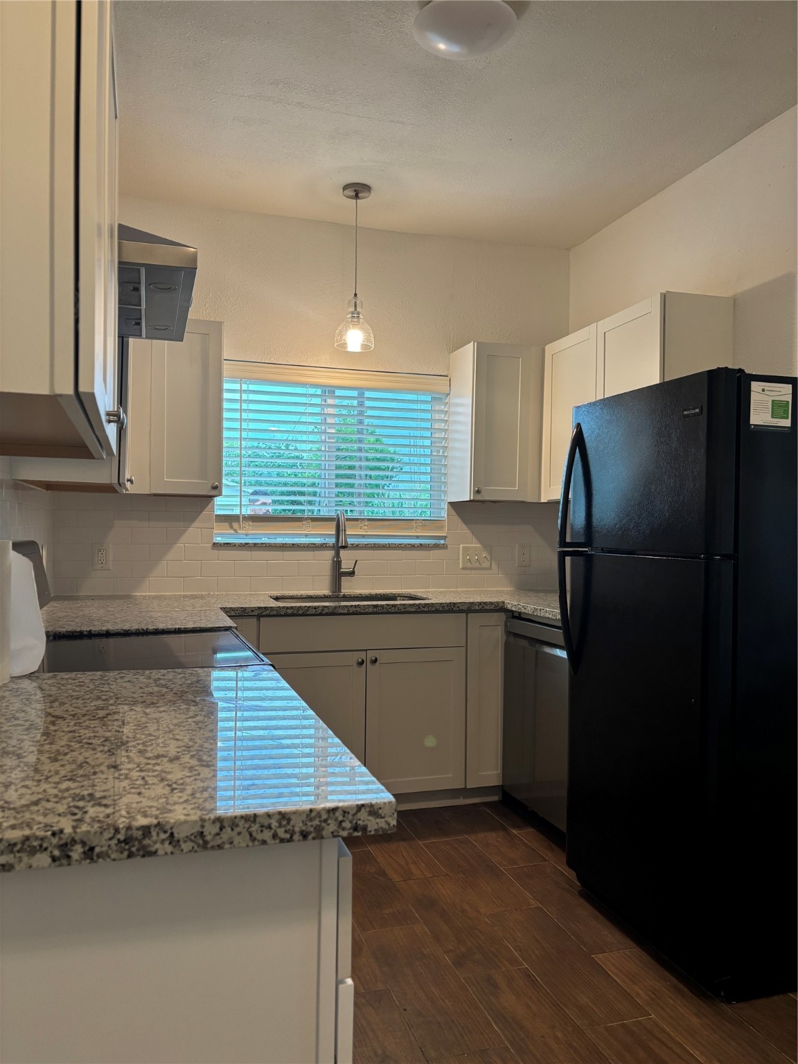 9834 Pelsey Street, Unit B Houston, TX 77029 - Photo 9 of 22 a kitchen with a refrigerator and a sink