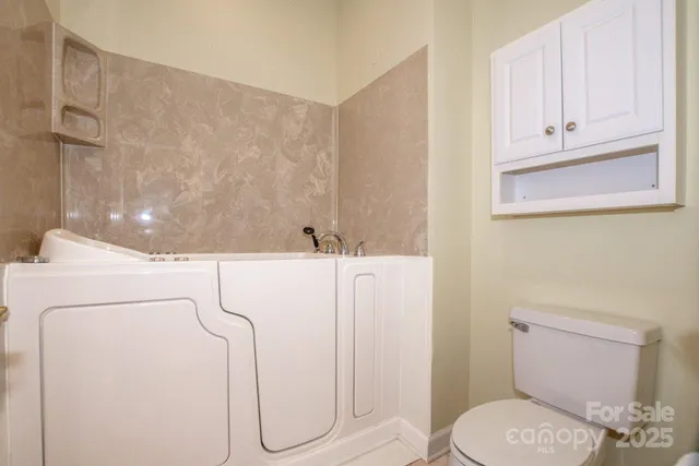 an aerial view of a house with a yard basket ball court and outdoor seating