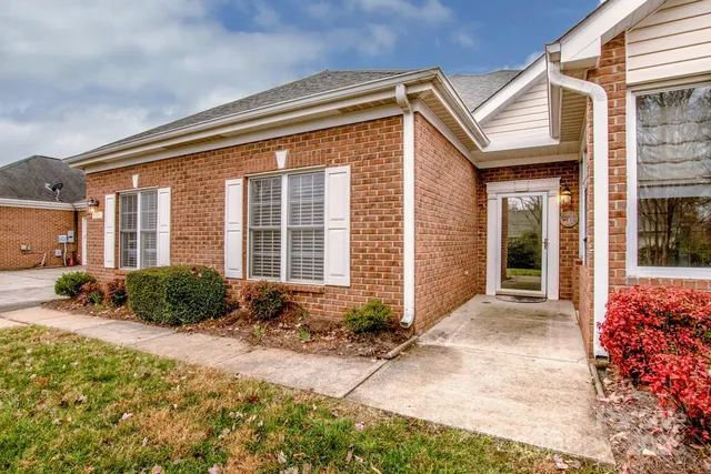 a view of a house with a small yard and plants