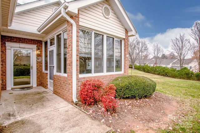 a view of a livingroom with wooden floor and a chandelier