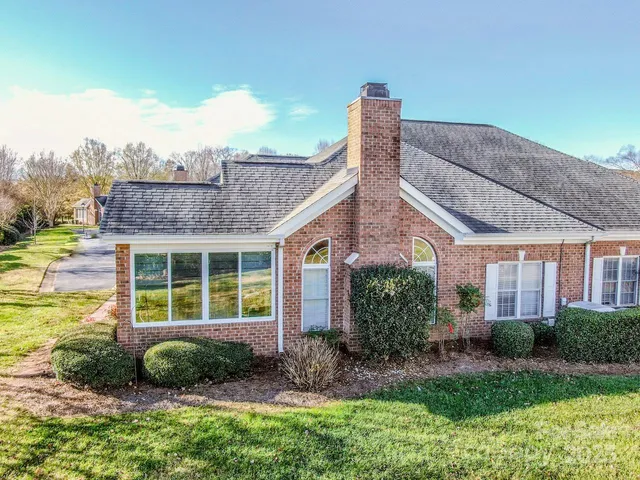 a living room with furniture chandelier and a flat screen tv