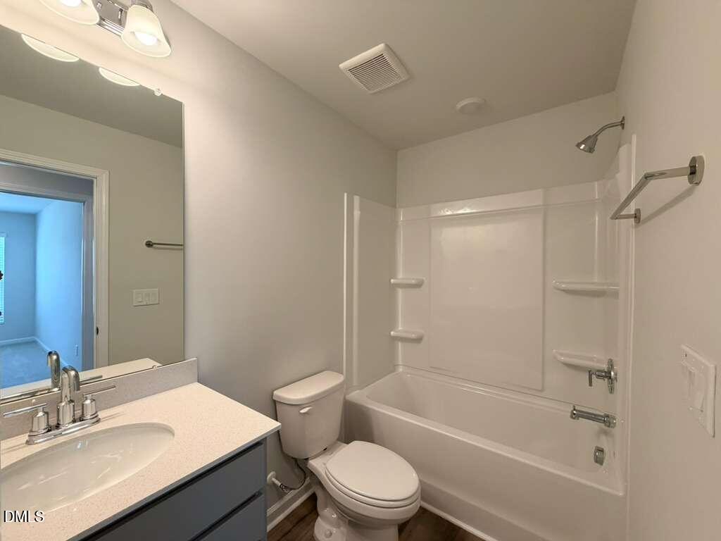 5024 Reader Way Durham, NC 27703 - Photo 22 of 26 a bathroom with a sink a toilet and a bathtub