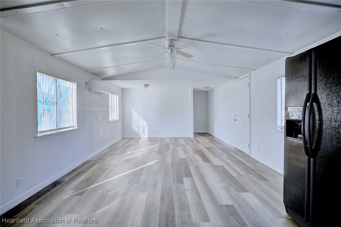 258-264 Griffin Road Wauchula, FL 33873 - Photo 6 of 33 a view of empty room with wooden floor and window