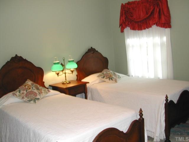 809 Davidson Street Raleigh, NC 27609 - Photo 12 of 12 a bedroom with two bed and a chair