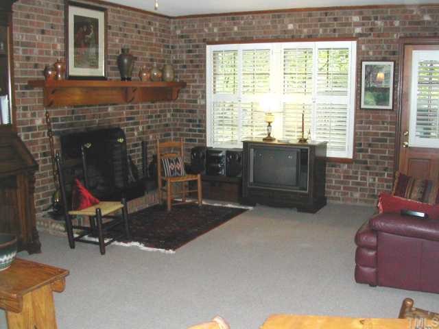 809 Davidson Street Raleigh, NC 27609 - Photo 5 of 12 a living room with furniture and a fireplace