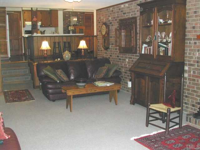 809 Davidson Street Raleigh, NC 27609 - Photo 6 of 12 a living room with a table and a fireplace