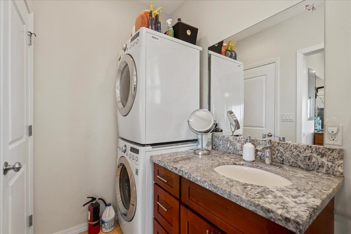 265 Kenolio Road Kihei, HI 96753 - Photo 13 of 50 a bathroom with a granite countertop sink and a mirror