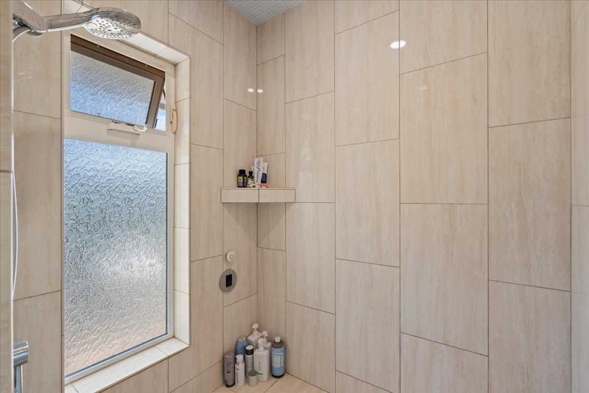 265 Kenolio Road Kihei, HI 96753 - Photo 14 of 50 a bathroom with a bathtub and shower