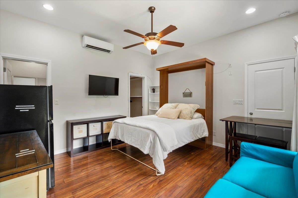 265 Kenolio Road Kihei, HI 96753 - Photo 17 of 50 a bedroom with a bed and a chandelier