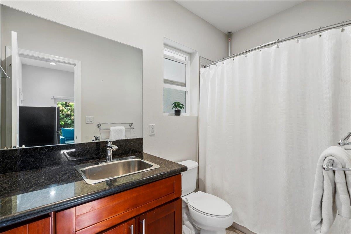 265 Kenolio Road Kihei, HI 96753 - Photo 19 of 50 a bathroom with a granite countertop sink and a mirror