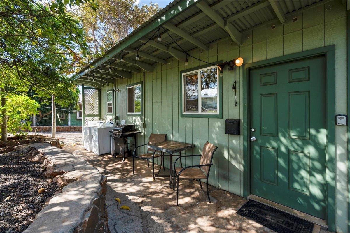 265 Kenolio Road Kihei, HI 96753 - Photo 24 of 50 a view of a patio with table and chairs and potted plants