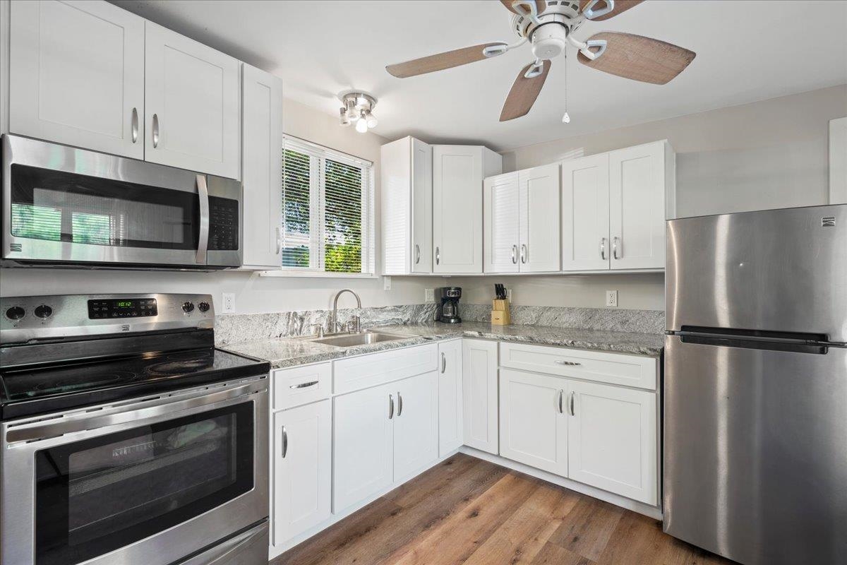 265 Kenolio Road Kihei, HI 96753 - Photo 28 of 50 a kitchen with stainless steel appliances a stove a sink and a refrigerator