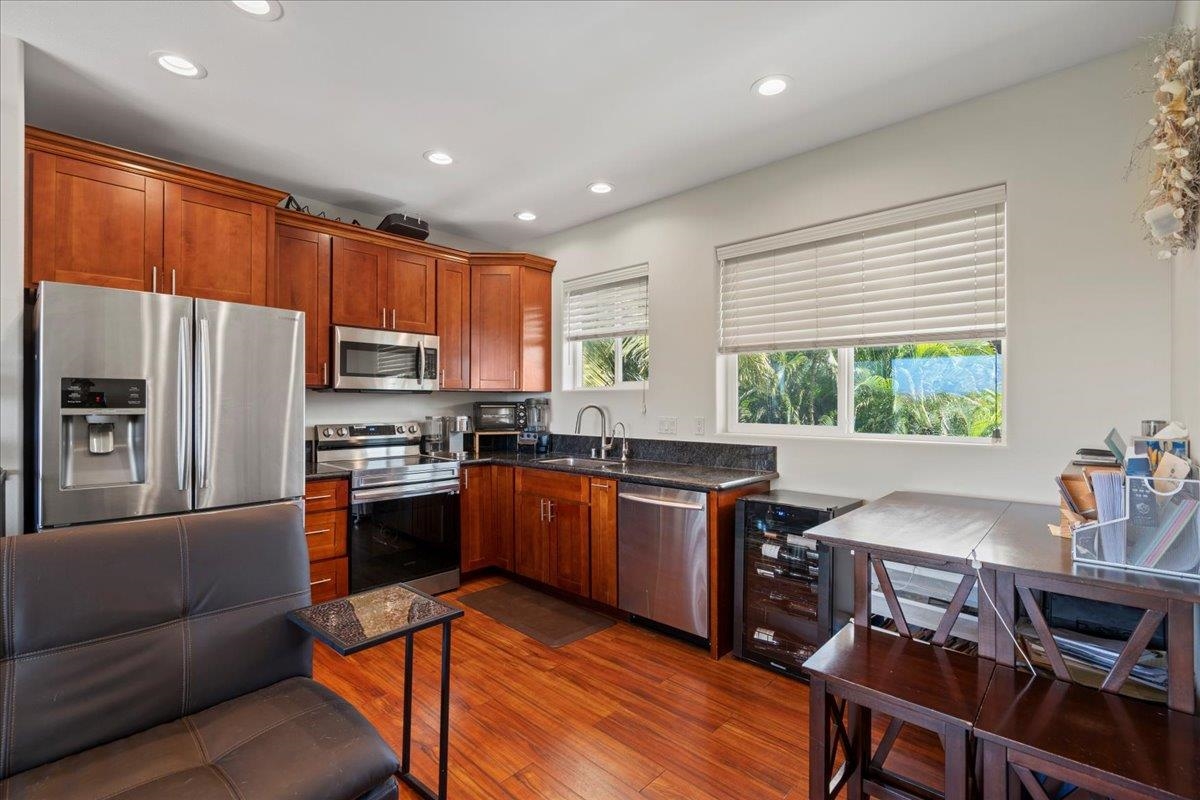 265 Kenolio Road Kihei, HI 96753 - Photo 10 of 50 a kitchen with stainless steel appliances granite countertop a refrigerator stove microwave and sink