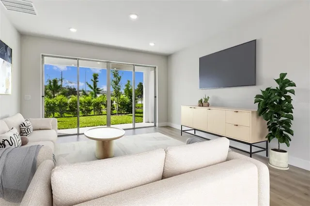 a view of an entryway with wooden floor