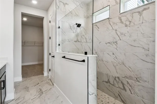 a spacious bathroom with a granite countertop sink and a mirror
