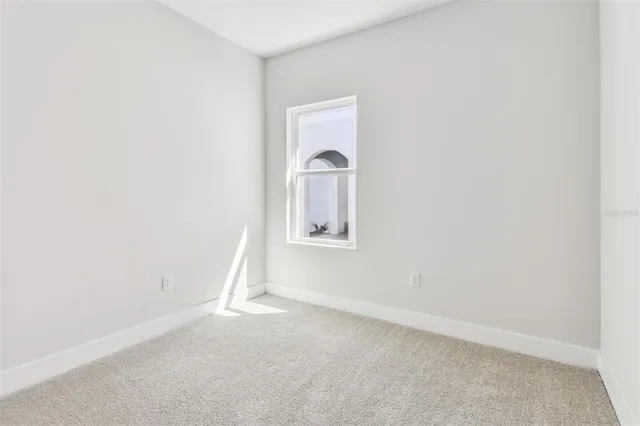 a view of an empty room with closet area