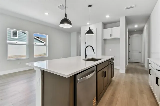 a kitchen with stainless steel appliances granite countertop a sink a stove and a refrigerator