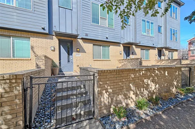 a large kitchen with kitchen island a stove a sink a center island and wooden floor