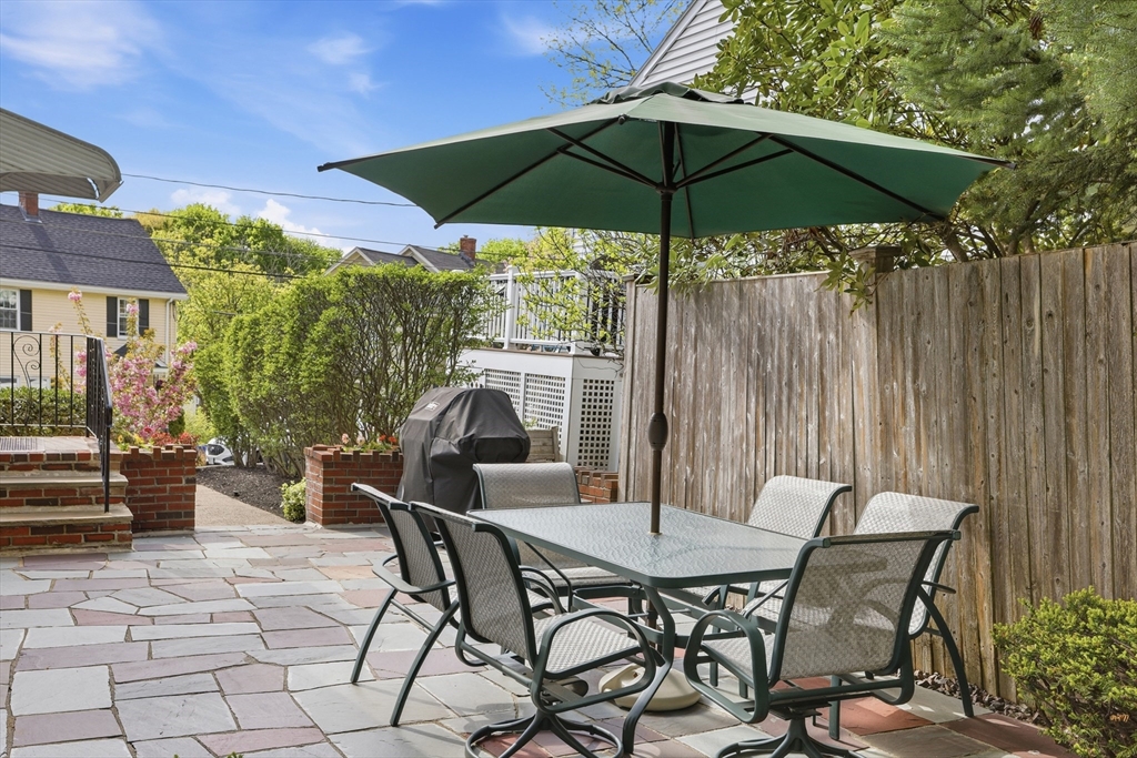 115 Collincote Street Stoneham, MA 02180 - Photo 20 of 25 a patio with a patio table and chairs