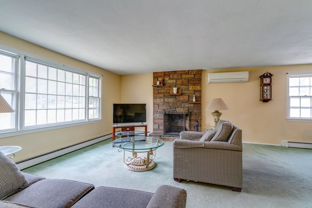 47 Kenney Street Canton, MA 02021 - Photo 3 of 8 a living room with furniture a fireplace and a flat screen tv