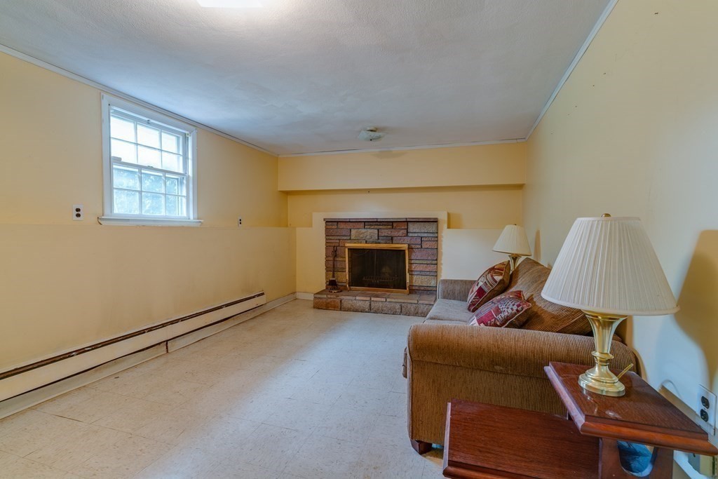 47 Kenney Street Canton, MA 02021 - Photo 5 of 8 a living room with furniture and a fireplace