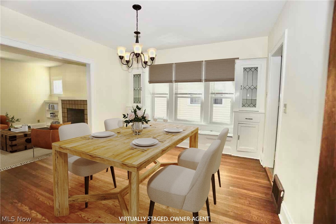 2168 Edgewood Road Cleveland, OH 44118 - Photo 6 of 41 1st fl dining room featuring a chandelier, hardwood floors, and window seat.