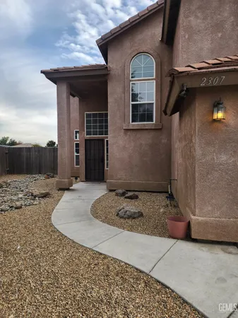 a front view of a house with parking space