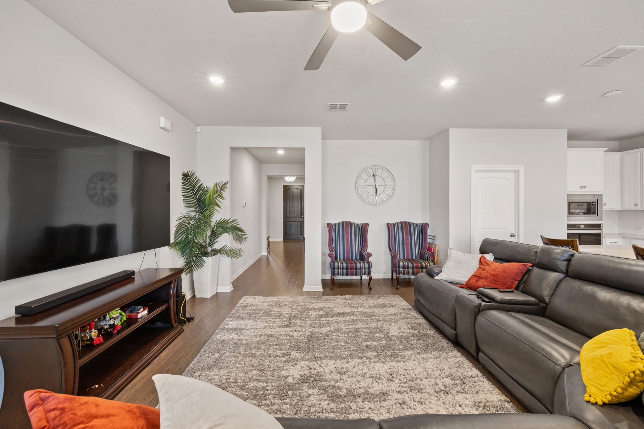 4009 Milano River Road Hutto, TX 78634 - Photo 11 of 39 Living area with a ceiling fan, dark wood finished floors, and recessed lighting