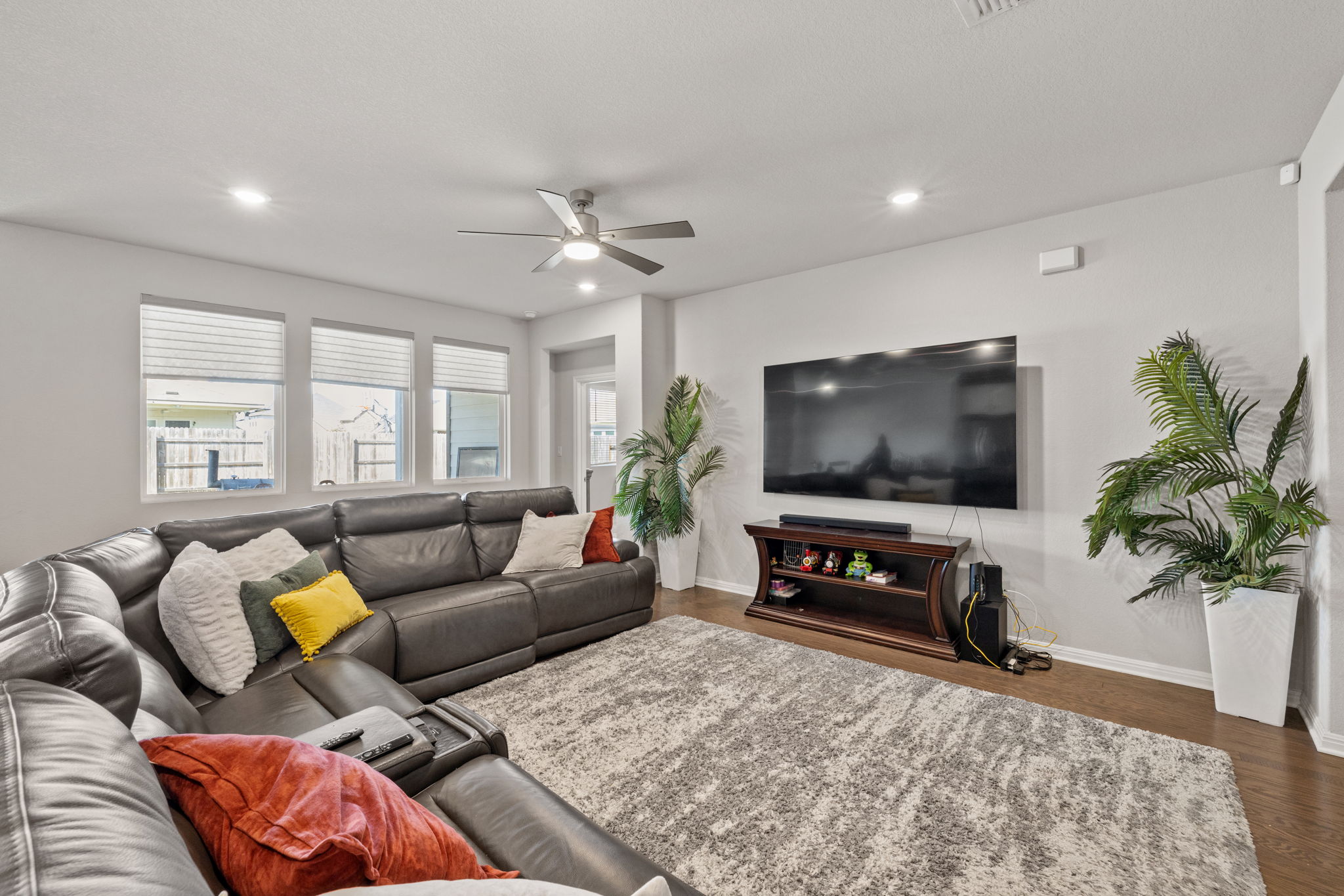 4009 Milano River Road Hutto, TX 78634 - Photo 12 of 39 Living room featuring a ceiling fan, dark wood-style flooring, and recessed lighting