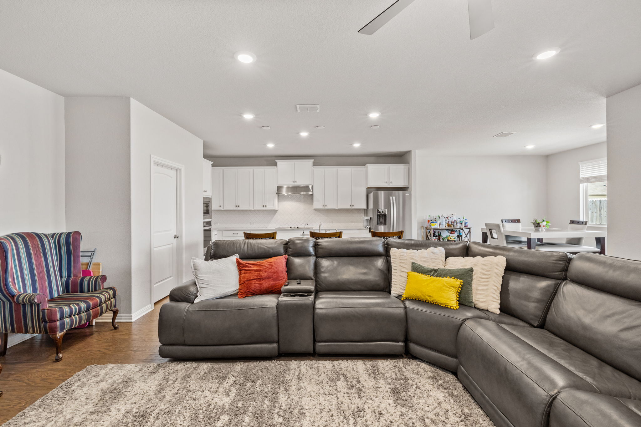 4009 Milano River Road Hutto, TX 78634 - Photo 14 of 39 Living area with ceiling fan, wood finished floors, and recessed lighting