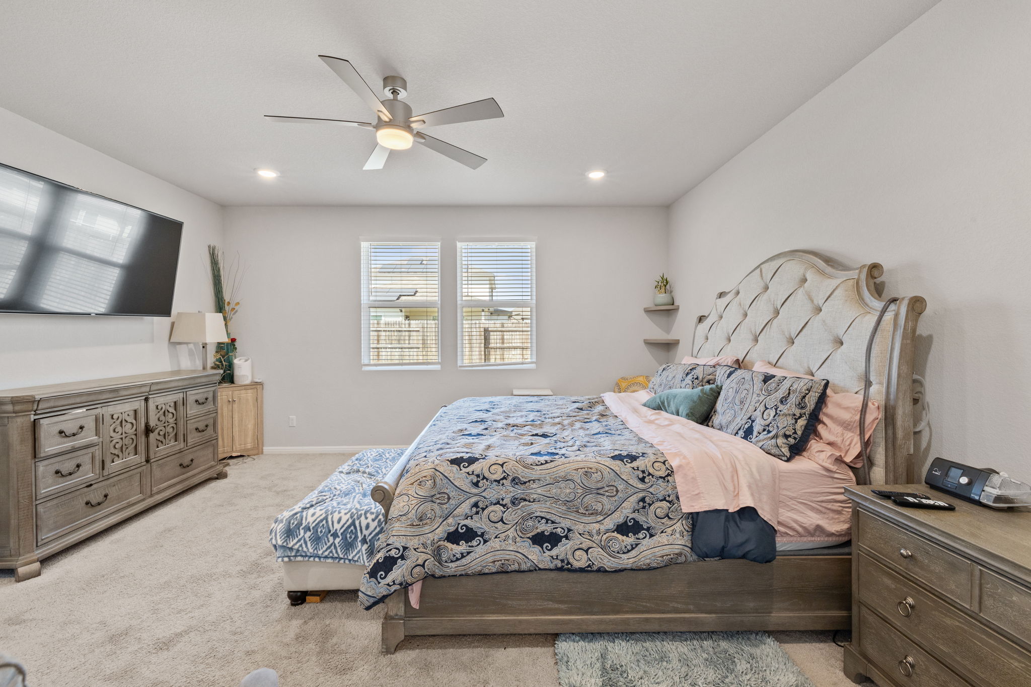 4009 Milano River Road Hutto, TX 78634 - Photo 18 of 39 Bedroom with light colored carpet, ceiling fan, and recessed lighting