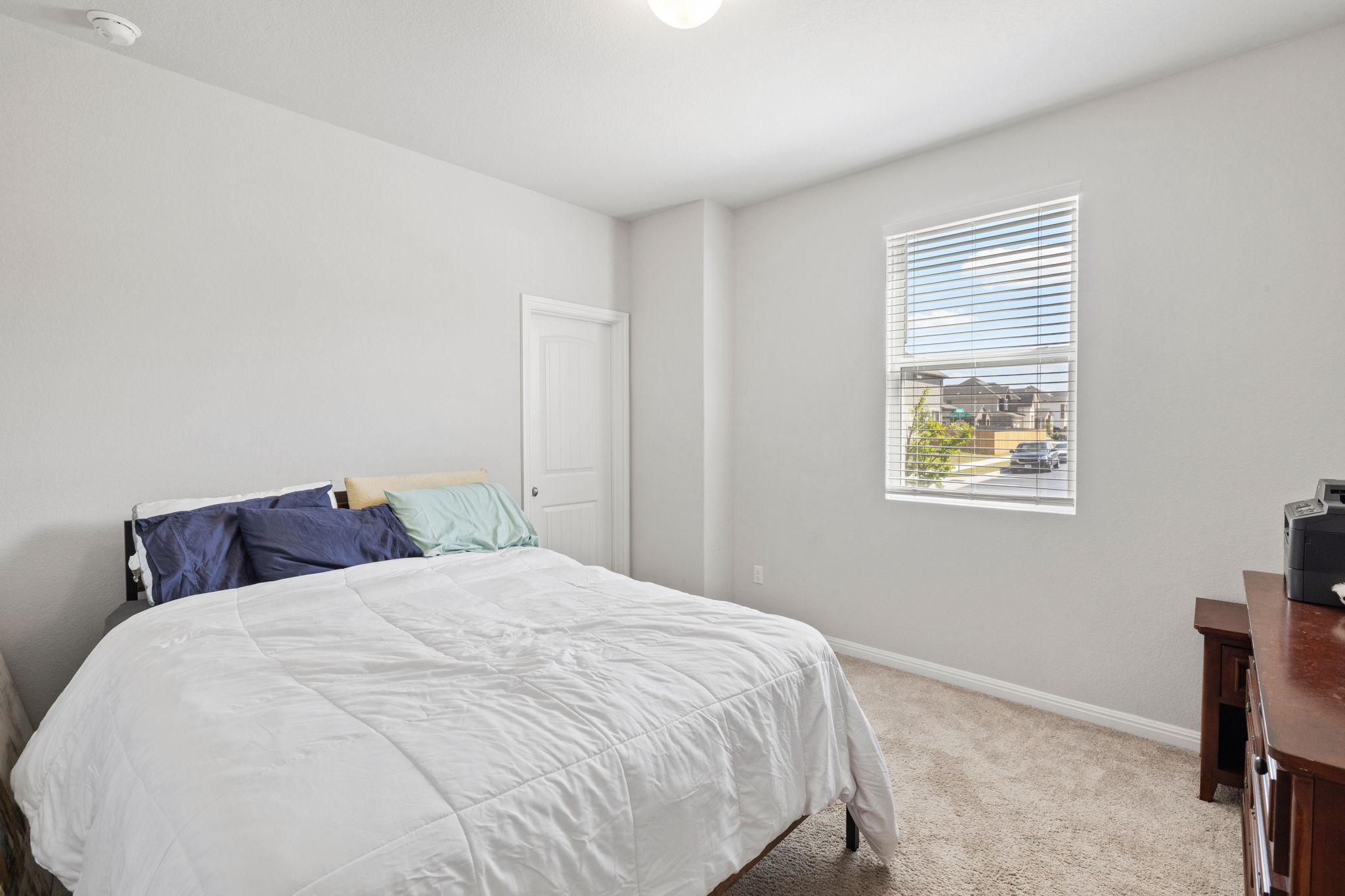 4009 Milano River Road Hutto, TX 78634 - Photo 23 of 39 Bedroom featuring light carpet and baseboards