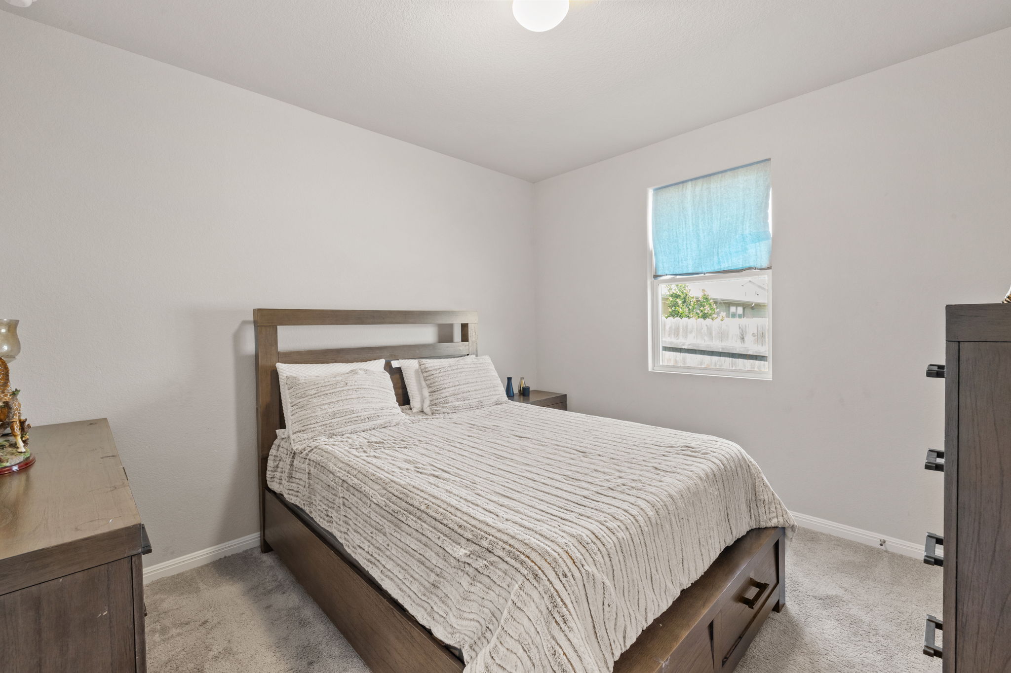 4009 Milano River Road Hutto, TX 78634 - Photo 25 of 39 Bedroom featuring light colored carpet and baseboards