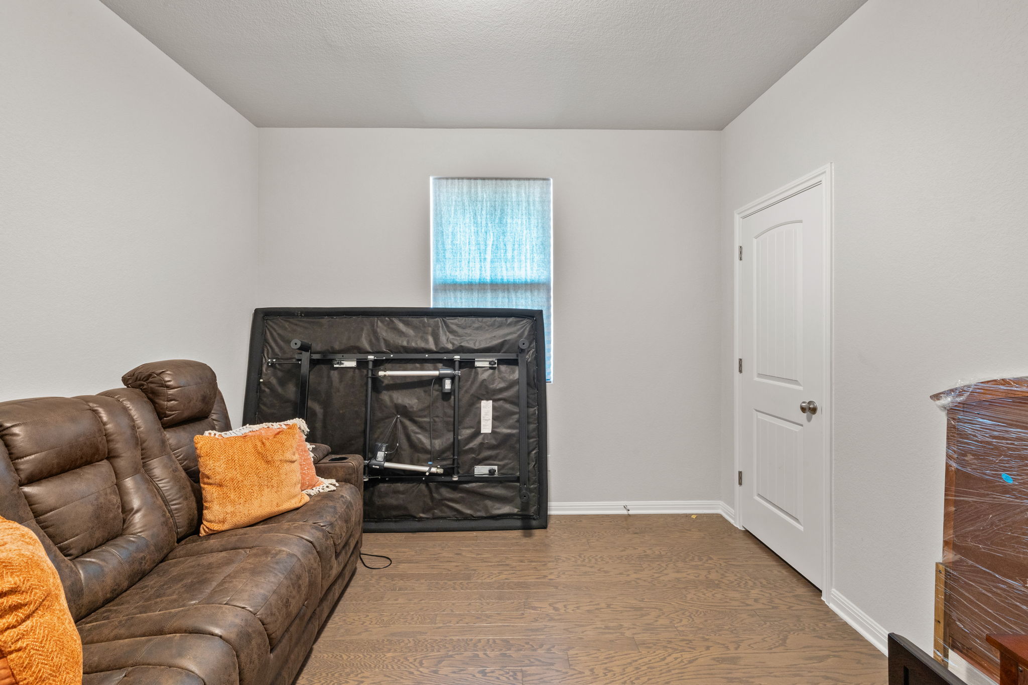 4009 Milano River Road Hutto, TX 78634 - Photo 27 of 39 Living room with wood finished floors and a textured ceiling