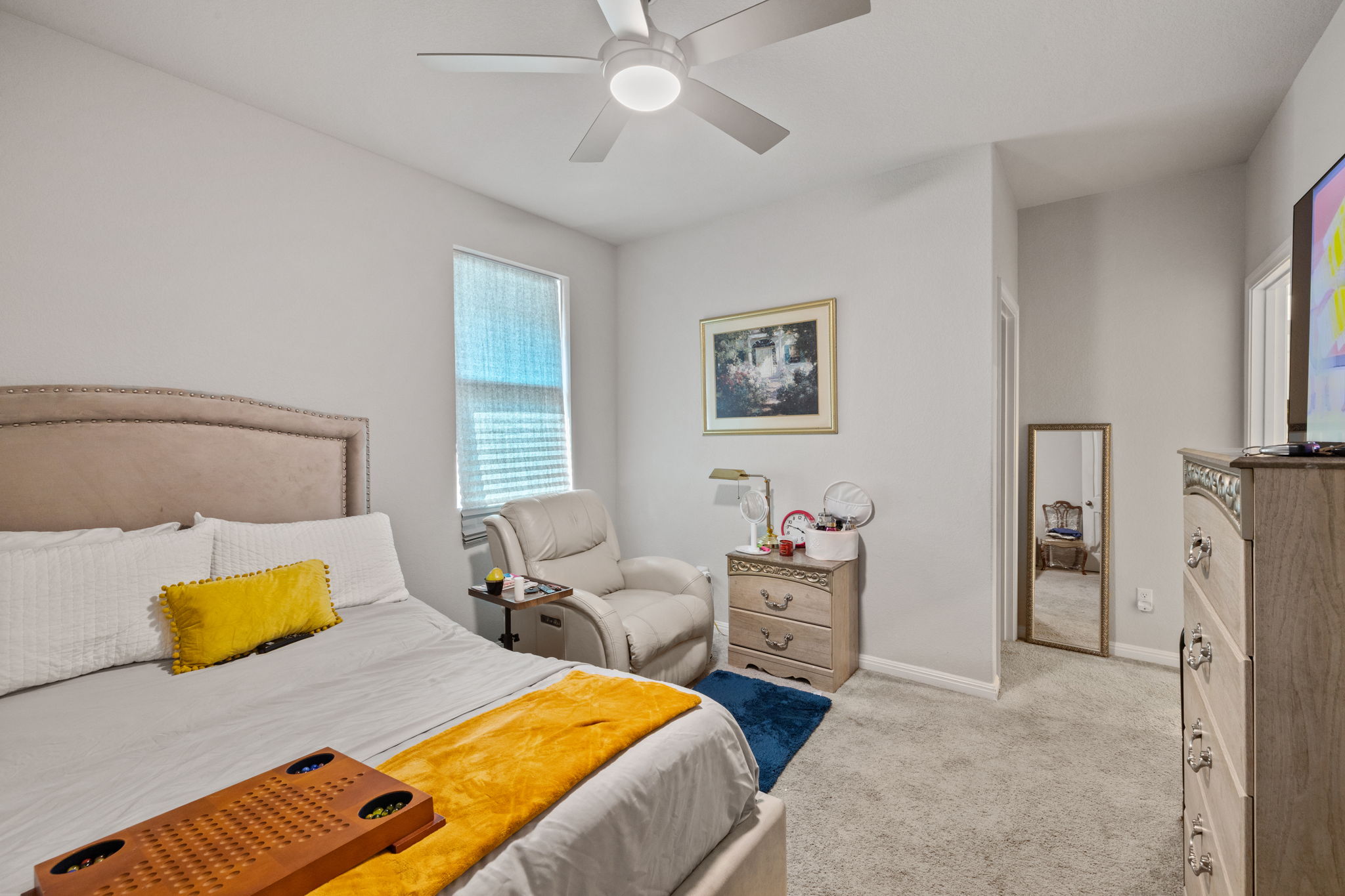 4009 Milano River Road Hutto, TX 78634 - Photo 32 of 39 Bedroom with light colored carpet and a ceiling fan
