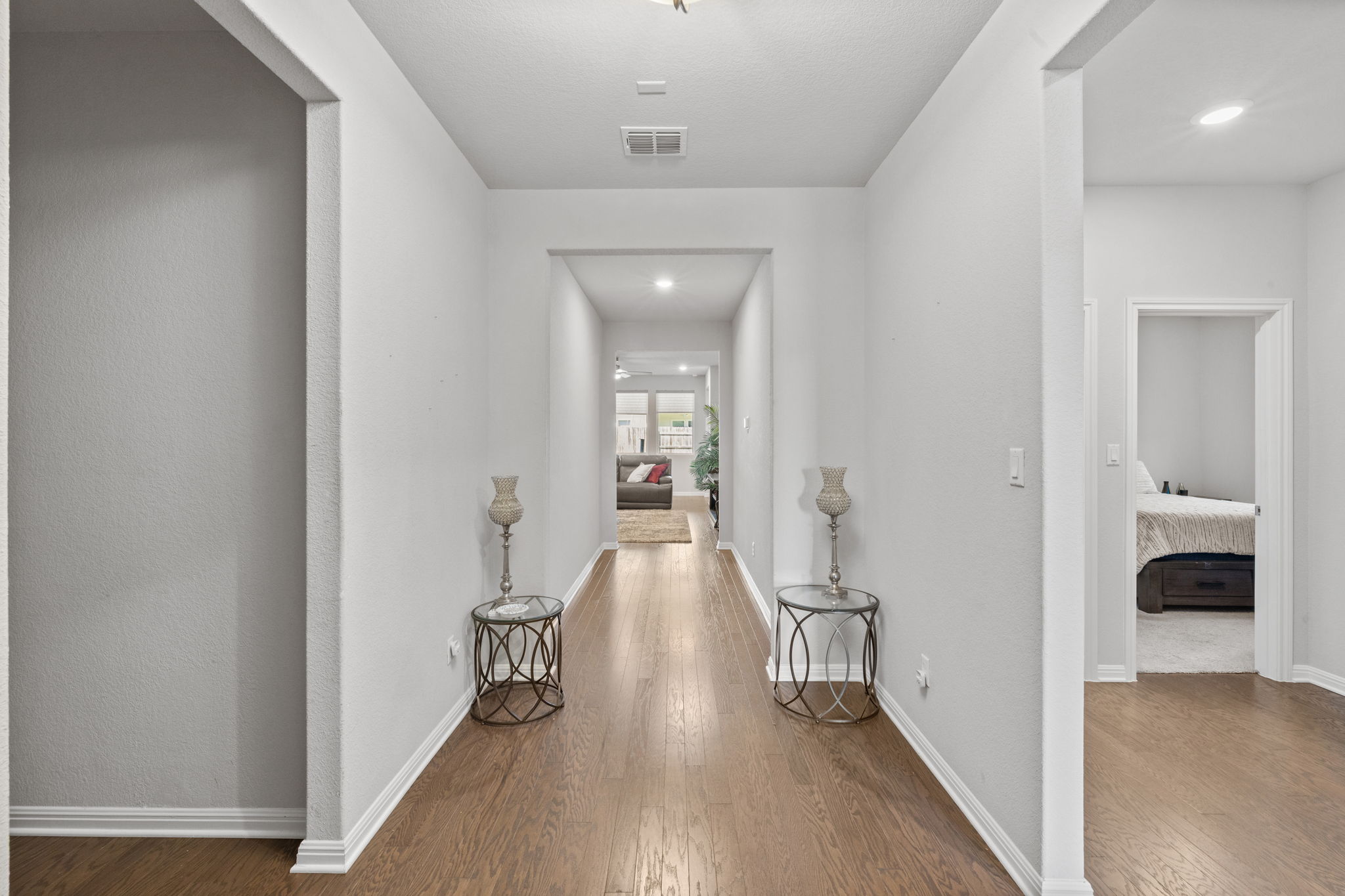 4009 Milano River Road Hutto, TX 78634 - Photo 7 of 39 Hallway featuring dark wood finished floors and recessed lighting