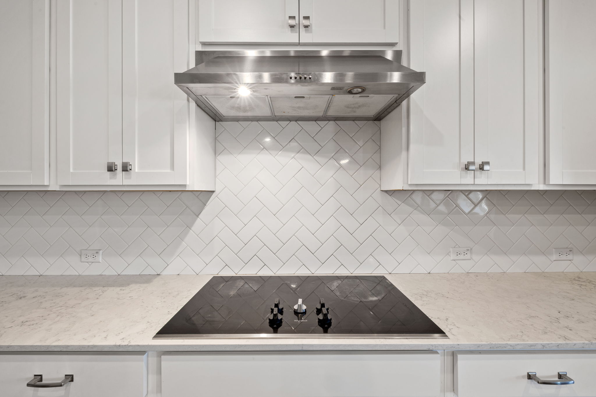 4009 Milano River Road Hutto, TX 78634 - Photo 10 of 39 Kitchen with light stone countertops, black electric cooktop, and white cabinets