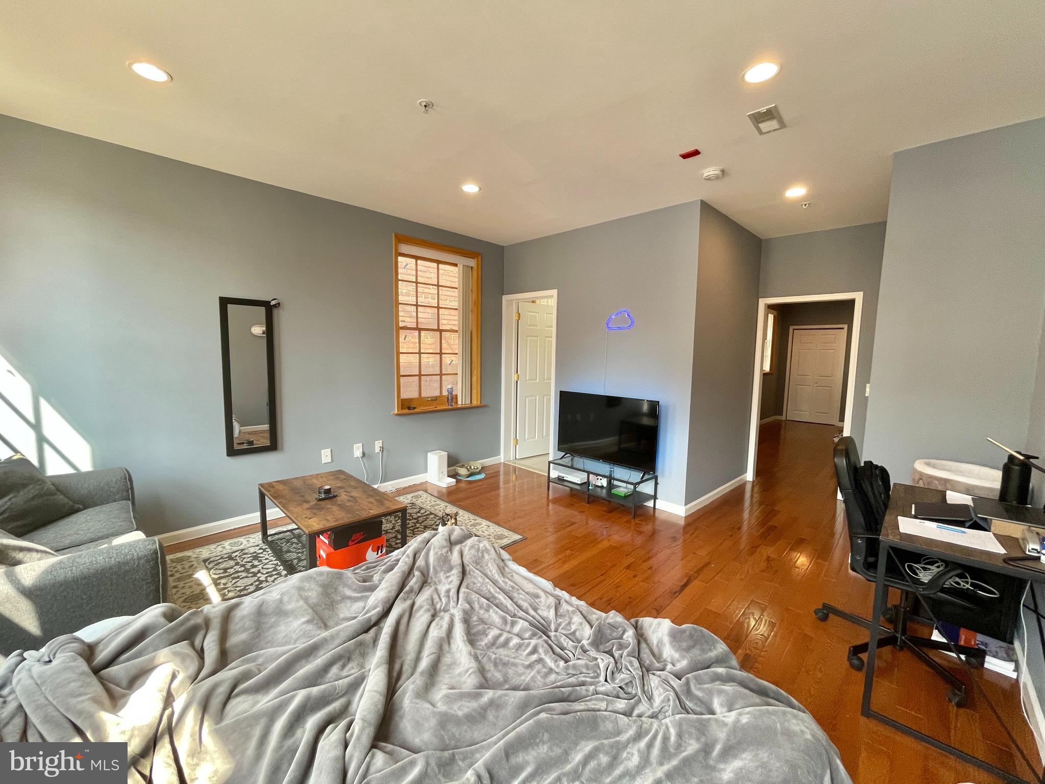 1316 Walnut Street, Unit 3R Philadelphia, PA 19107 - Photo 14 of 15 a bed room with a bed and a couch