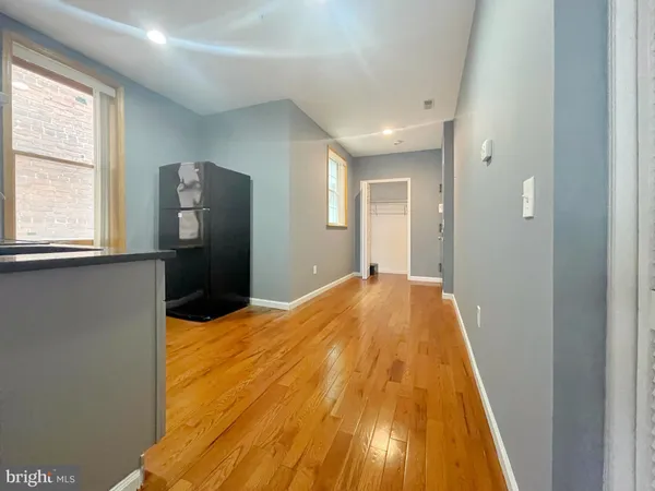 a view of a bedroom with wooden floor and a bed