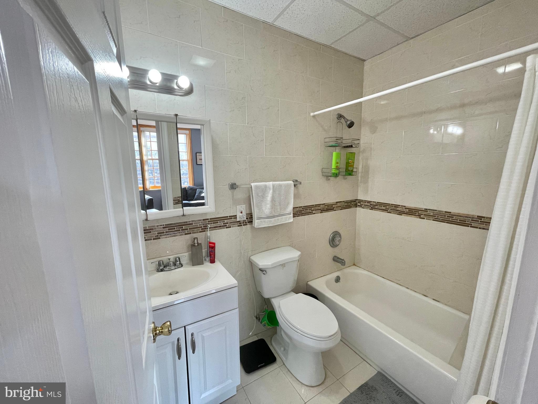 1316 Walnut Street, Unit 3R Philadelphia, PA 19107 - Photo 10 of 15 a bathroom with a toilet sink and mirror