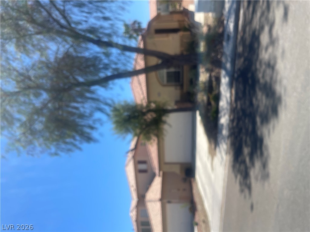 9082 Manalang Road Las Vegas, NV 89123 - Photo 1 of 1 A classic tiled roofline defines this residence, nestled against a clear, azure sky.